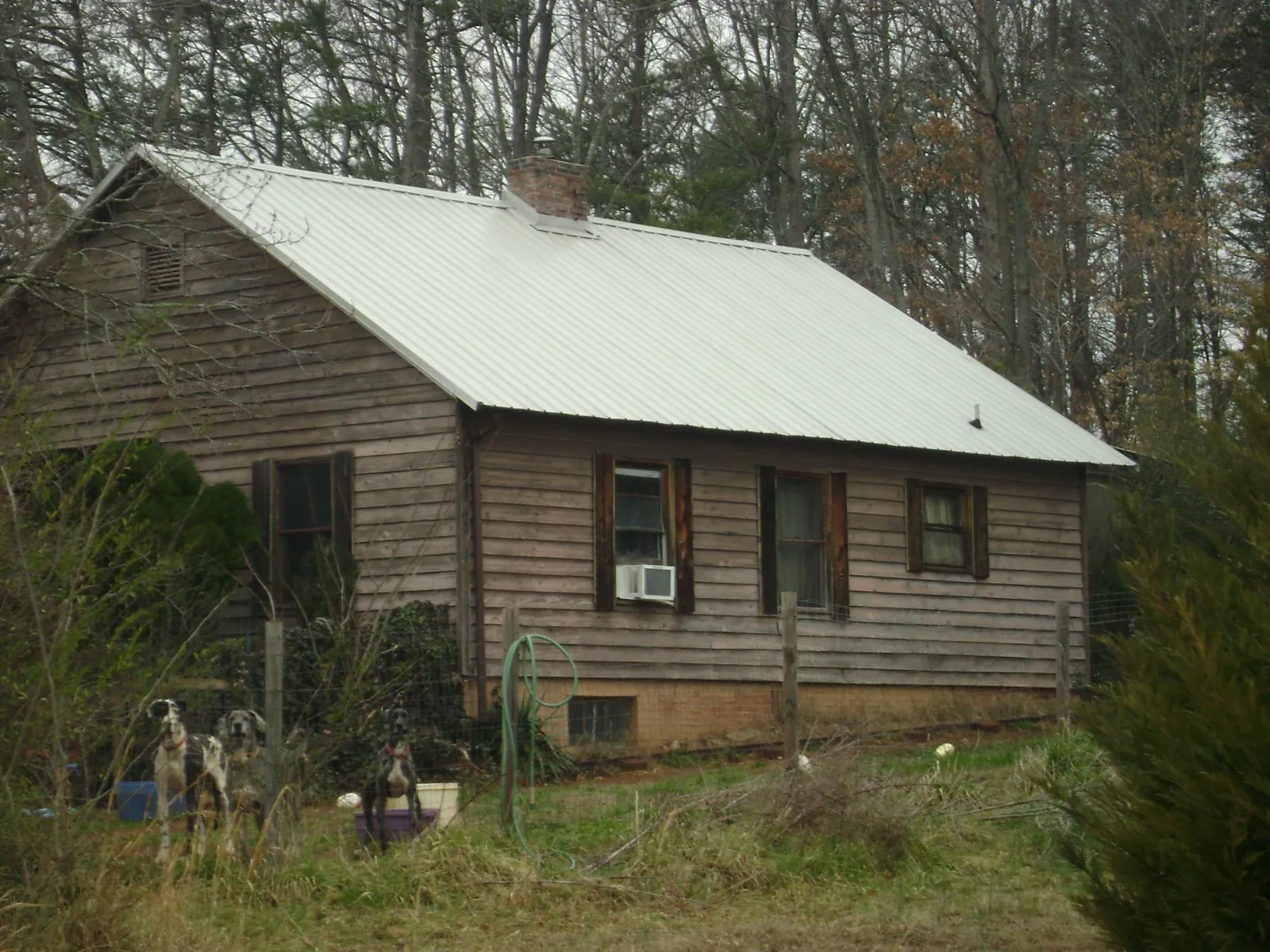 White metal roof on an old wood sided farmhouse, from a Metal Roof Installation job in Home